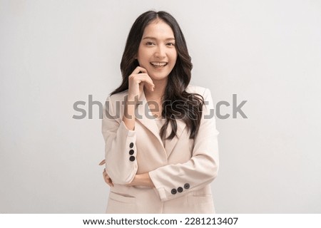Smiling positive, attractive asian young woman, girl in beige suit formal dress, portrait elegant of pretty with long black hair, feeling happy looking at camera standing isolated on white background.