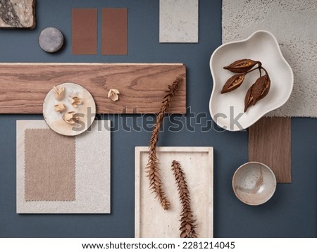 Elegant flat lay composition with textile and paint samples, panels and cement tiles. Stylish interior designer moodboard. Blue, beige and brown color palette. Copy space. Template. 