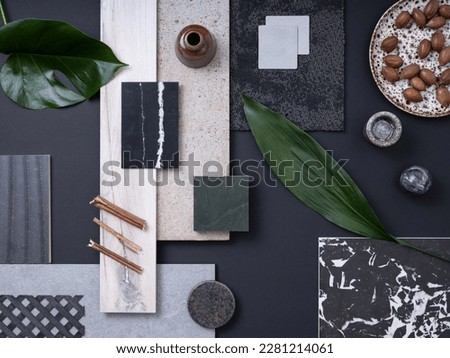 Classic flat lay composition in grey and navy color palette with  textile and paint samples, lamella panels, leaves and tiles. Architect and interior designer moodboard. Top view. Copy space. 