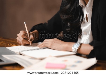 Asian businesswoman reviewing document reports and Signing Contract at office workplace with computer laptop. legal expert, professional lawyer reading and checking financial documents or insurance