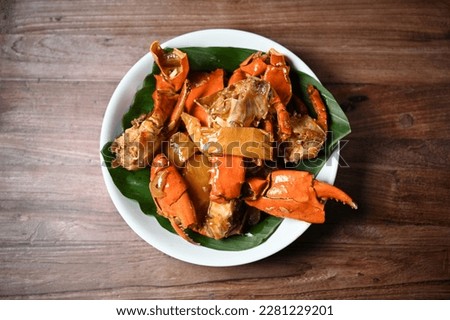 Kepiting Asam Manis is a traditional Indonesian Food, Crabs with sweet and sour sauce. Top View. Selective Focus. Royalty-Free Stock Photo #2281229201