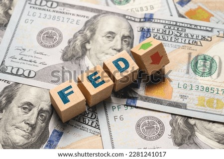 Wooden cubes with FED and up-down arrows over 100 usd. Fed rate hike concept to curb inflation Royalty-Free Stock Photo #2281241017