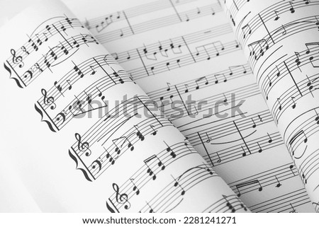 Sheets of paper with music notes as background, closeup view Royalty-Free Stock Photo #2281241271