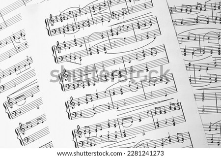 Music sheets. Melodies written with different musical symbols as background, closeup Royalty-Free Stock Photo #2281241273
