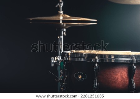 Snare drum and cymbals on a black background.