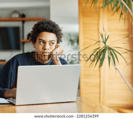 Father and son doing homework with laptop fighting and arguing over learning at home. Father and teenage son using laptop. Boy and dad sitting at home working with notebook, boy being bored looking  Royalty-Free Stock Photo #2281256399
