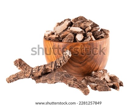 Calamus root in wooden bowl, isolated on white background. Sweet flag, sway or muskrat root. Dry root of Acorus calamus. Royalty-Free Stock Photo #2281257849