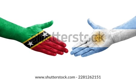 Handshake between Argentina and Saint Kitts and Nevis flags painted on hands, isolated transparent image.