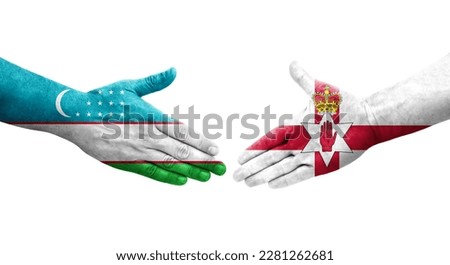 Handshake between Uzbekistan and Northern Ireland flags painted on hands, isolated transparent image.