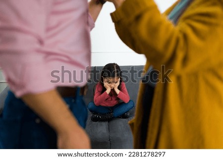 Depressed sad child feeling in the middle of her parents fight about child custody after divorce Royalty-Free Stock Photo #2281278297