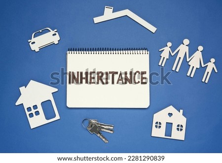 Notebook with word Inheritance, different cutouts and keys on blue background, flat lay Royalty-Free Stock Photo #2281290839