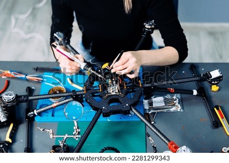 Engineer working on racing fpv drone combat kamikaze bomber in workshop. Royalty-Free Stock Photo #2281299343