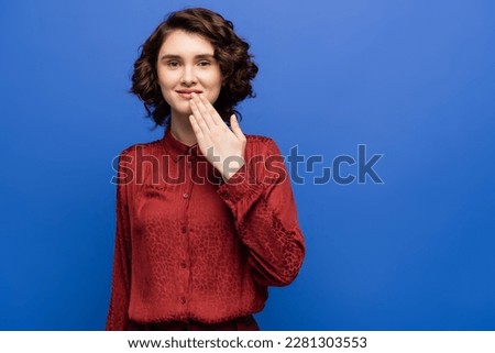 happy young woman telling thank you on sign language isolated on blue Royalty-Free Stock Photo #2281303553