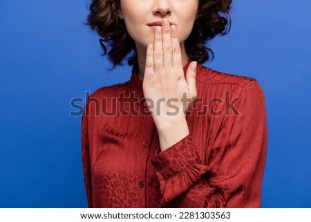cropped view of woman in red blouse telling thank you on sign language isolated on blue Royalty-Free Stock Photo #2281303563