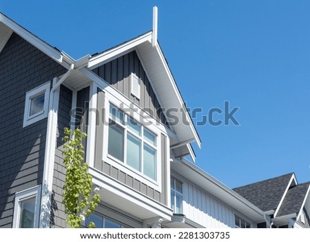 Top of residential townhouse on blue sky background Royalty-Free Stock Photo #2281303735
