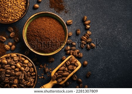 Roasted coffee beans, ground coffee and instant coffee in bowls at dark background. Royalty-Free Stock Photo #2281307809