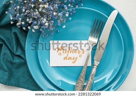 Stylish table setting with gypsophila flowers for Mother's Day celebration, closeup Royalty-Free Stock Photo #2281322069