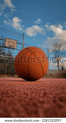 Close shot of basket ball With basketball court on background