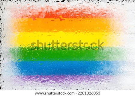 LGBT flag. Flag of LGBTq on the background of water drops. Flag with raindrops. Splashes on glass. Abstract background