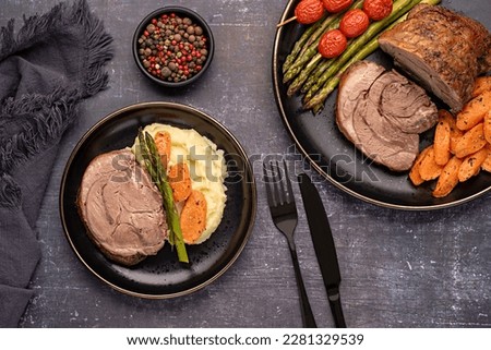 Food photography of roasted lamb, carrot, asparagus, tomato, seasoning, pepper
