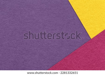 Texture of craft violet color paper background with purple and yellow border. Vintage abstract lavender cardboard. Presentation template and mockup with copy space. Felt backdrop closeup.