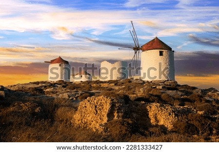 Traditional typical  greek windmills. Amorgos island in Cyclades, Chora village over sunset