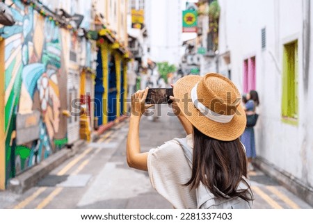 Young woman tourist with backpack walking at Haji Lane in Singapore Royalty-Free Stock Photo #2281337403
