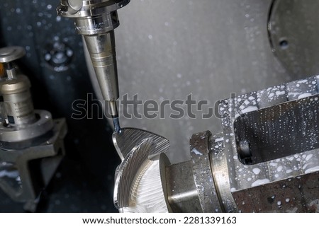 Close up the 5 axis machining center cutting the boat propeller parts  parts with taper ball end mill tool. The hi-precision parts  manufacturing process by multi-axis CNC milling machine. Royalty-Free Stock Photo #2281339163