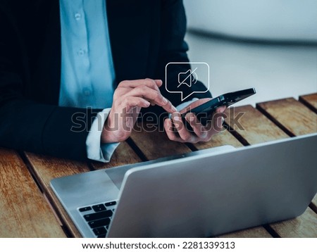 Silent mode concept. Silent or mute sound icon turn activated on appear in speech bubble on mobile smart phone in hand while business person work with laptop computer on desk in office or workplace. Royalty-Free Stock Photo #2281339313