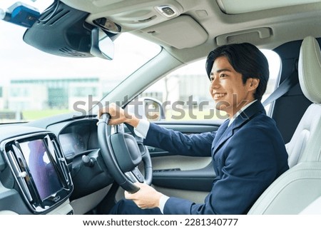 Young Asian man driving a car. Royalty-Free Stock Photo #2281340777