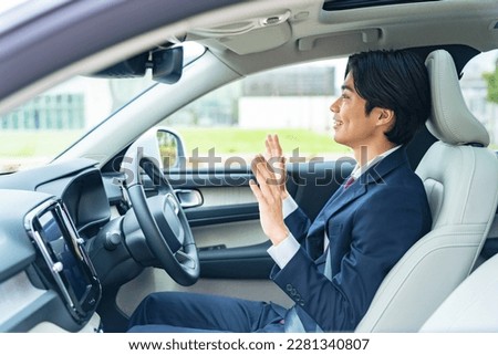 A man who enjoys hands-free driving in a self-driving car. Cruise control. Royalty-Free Stock Photo #2281340807