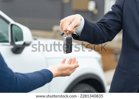 Man handing car smart key. Car rental. Car sharing. Royalty-Free Stock Photo #2281340835