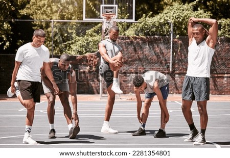 Fitness, exercise and basketball men stretching or workout their body on a sport court. Training male athletes prepare muscle warm up before practice or game at a sports venue or club for health