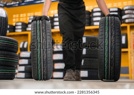 A tire changer checks new tires in stock to take them to a service center or wheel shop. Tire warehouse for the automobile industry