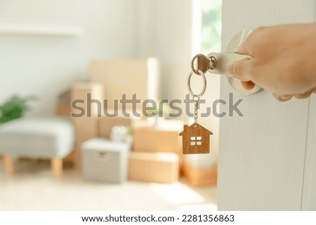 Moving house, relocation. Man hold key house keychain in new apartment. move in new home. Buy or rent real estate. flat tenancy, leasehold property, new landlord, investment, dwelling, loan, mortgage. Royalty-Free Stock Photo #2281356863