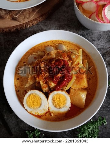 aerial shot of lontong cap go meh Chinese food on a black background 