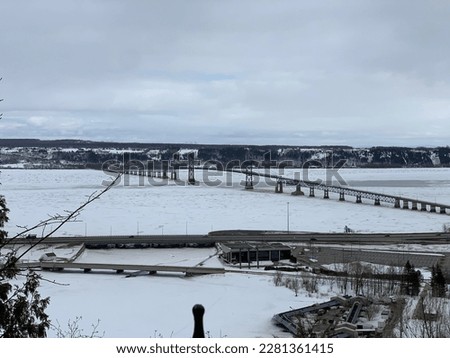 Picture of a bridge over the St. Lawrence River during wintertime. This picture was taken from Montmorency Falls. 