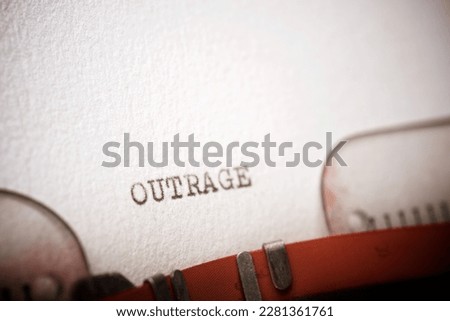 Outrage word written with a typewriter. Royalty-Free Stock Photo #2281361761