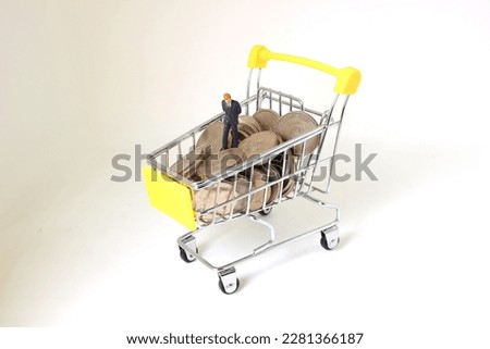a shopping trolley with coins, finance concept