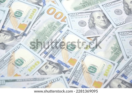 A pile of one hundred US banknotes with president portraits. Cash of hundred dollar bills, dollar background image with high resolution.