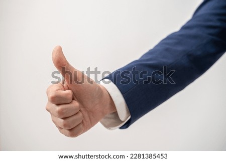 close up of businessman showing thumbs-up
