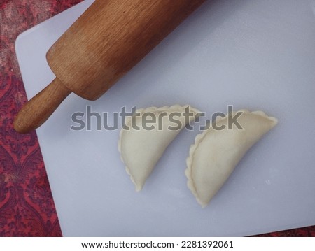 A picture of raw curry puff pastry which are preparing for frying.
