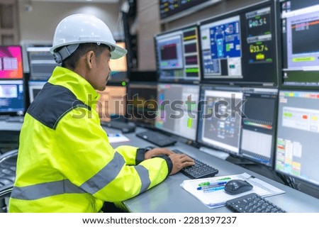 Engineer working at control room,Manager control system,Technician man monitoring program from a lot of monitor Royalty-Free Stock Photo #2281397237