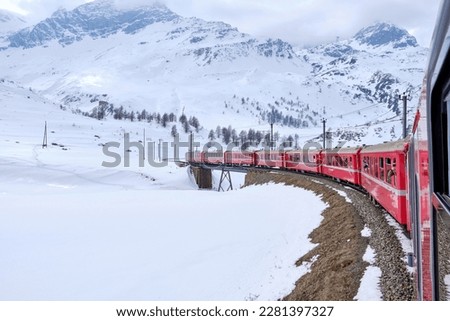 Bernina mountain pass. The famous red train is crossing the white lake. Amazing landscape of the Switzerland land. Famous destination and tourists attraction. Best of Swiss Royalty-Free Stock Photo #2281397327