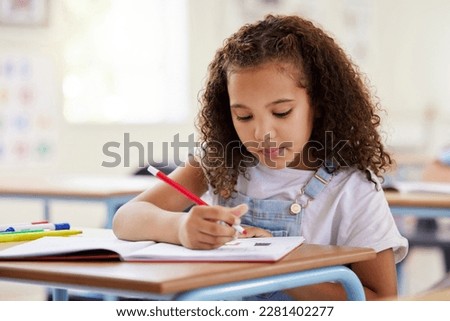 Learning, drawing and girl in classroom for education, exam or studying with book. Preschool, creativity development and serious kid or student coloring for art in notebook in kindergarten or academy Royalty-Free Stock Photo #2281402277