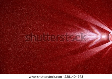 On a red gradient fine-grained background, a light purple diffused beam of light
