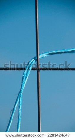 Blue chord in rural fence
