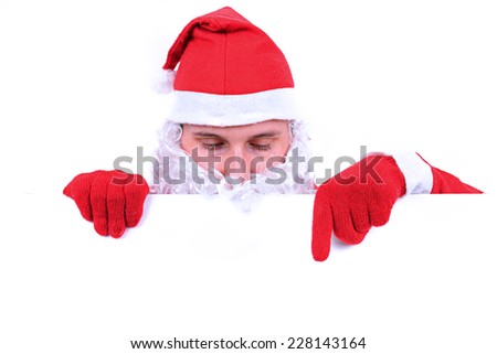 Thoughtful Santa Claus with christmas ornaments is seating