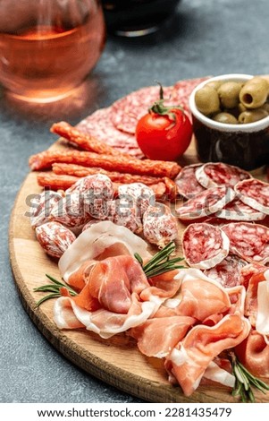 Antipasto catering platter with bacon, jamon, sausage and wine. Antipasti Dinner or aperitivo party concept. top view. Royalty-Free Stock Photo #2281435479