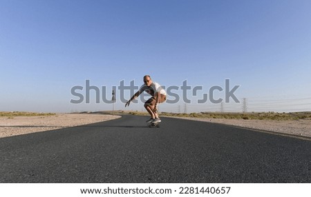 Adult male riding on a skateboard
